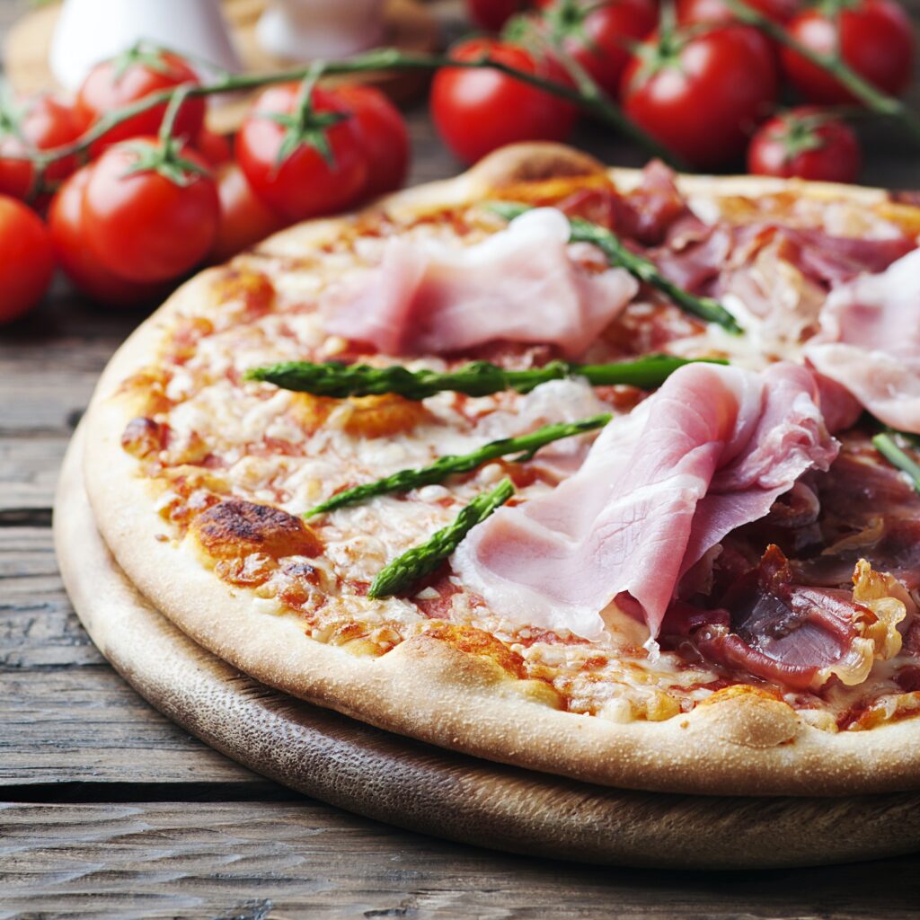 Italian pizza with ham and asparagus